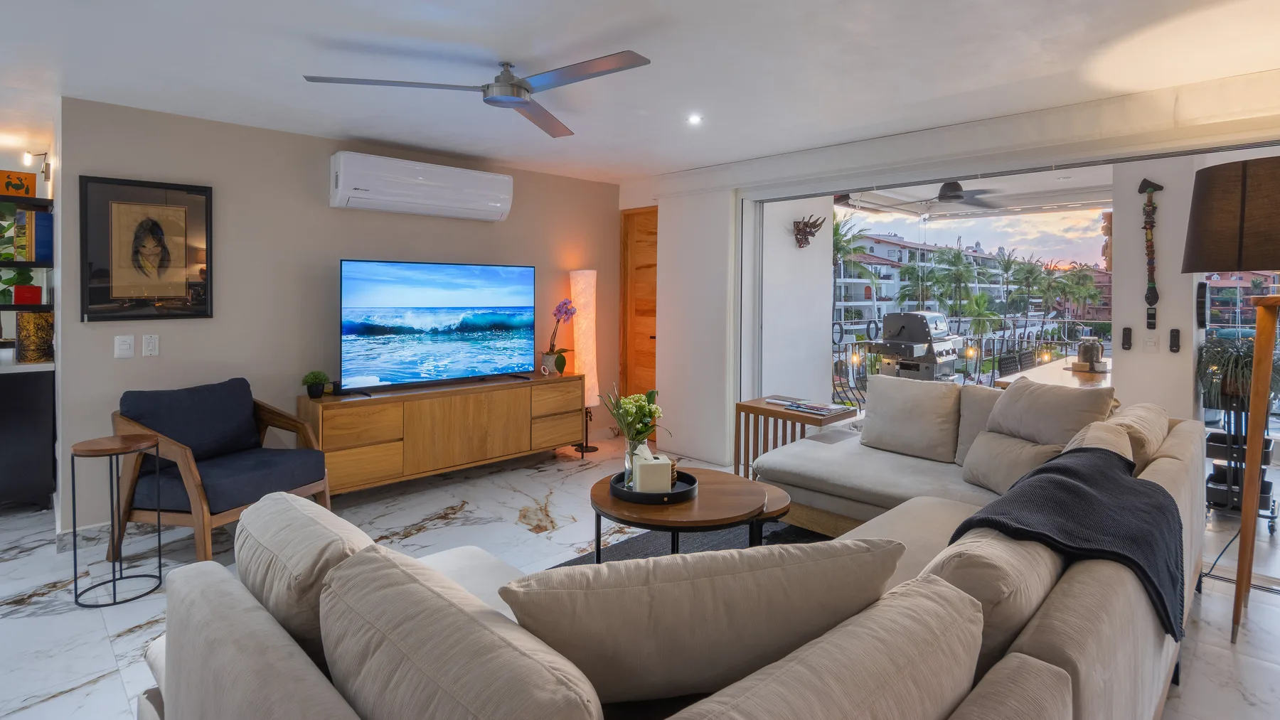 Living room with sectional seating facing the marina windows