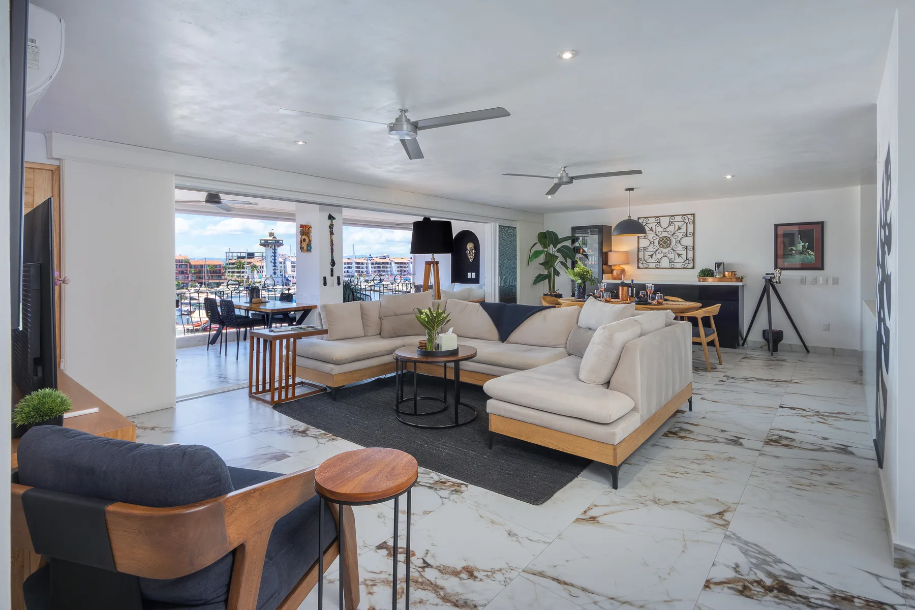 Great room and dining area on marble-look porcelain floors