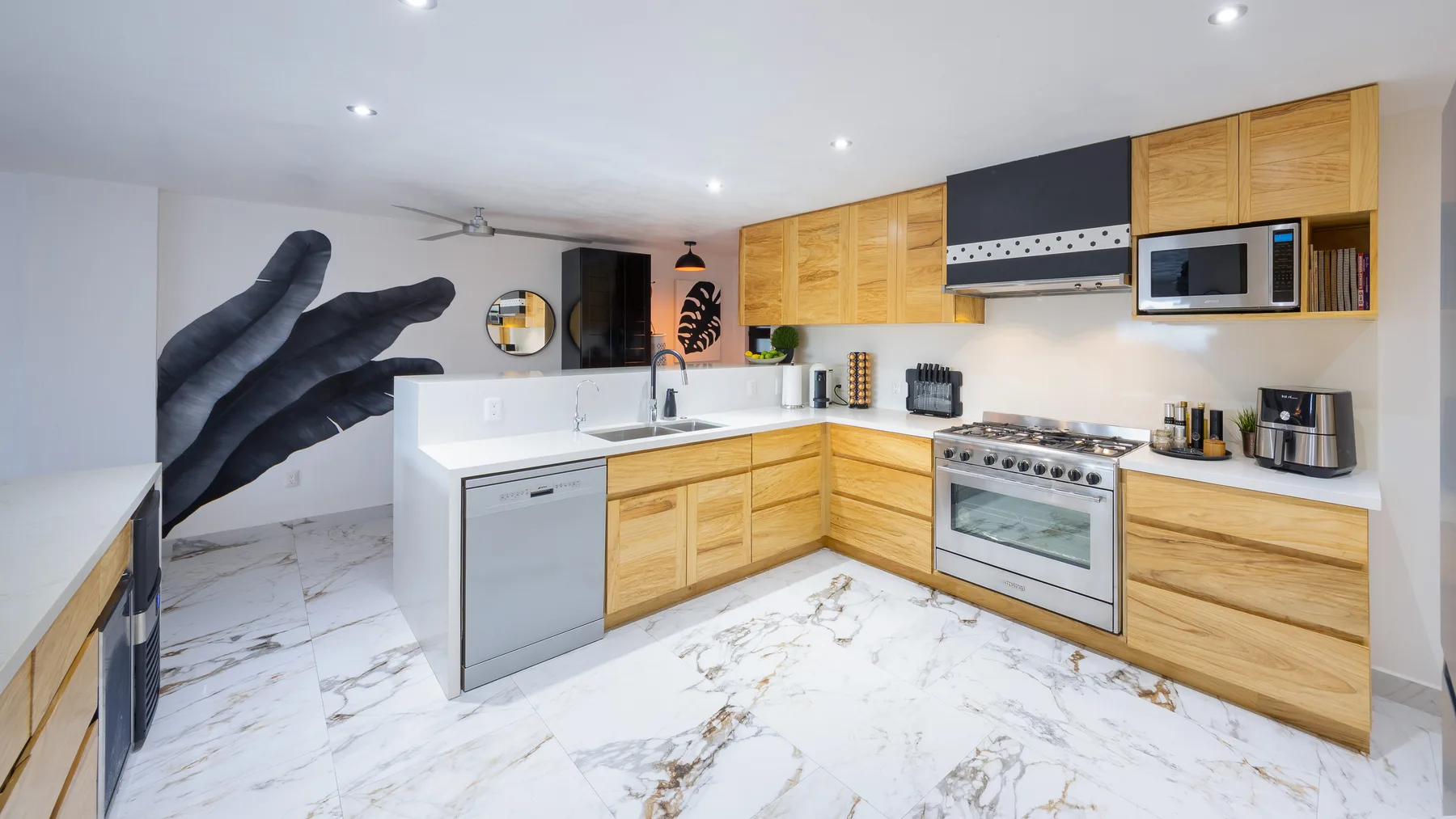 Gas range and quartz counters in the renovated kitchen