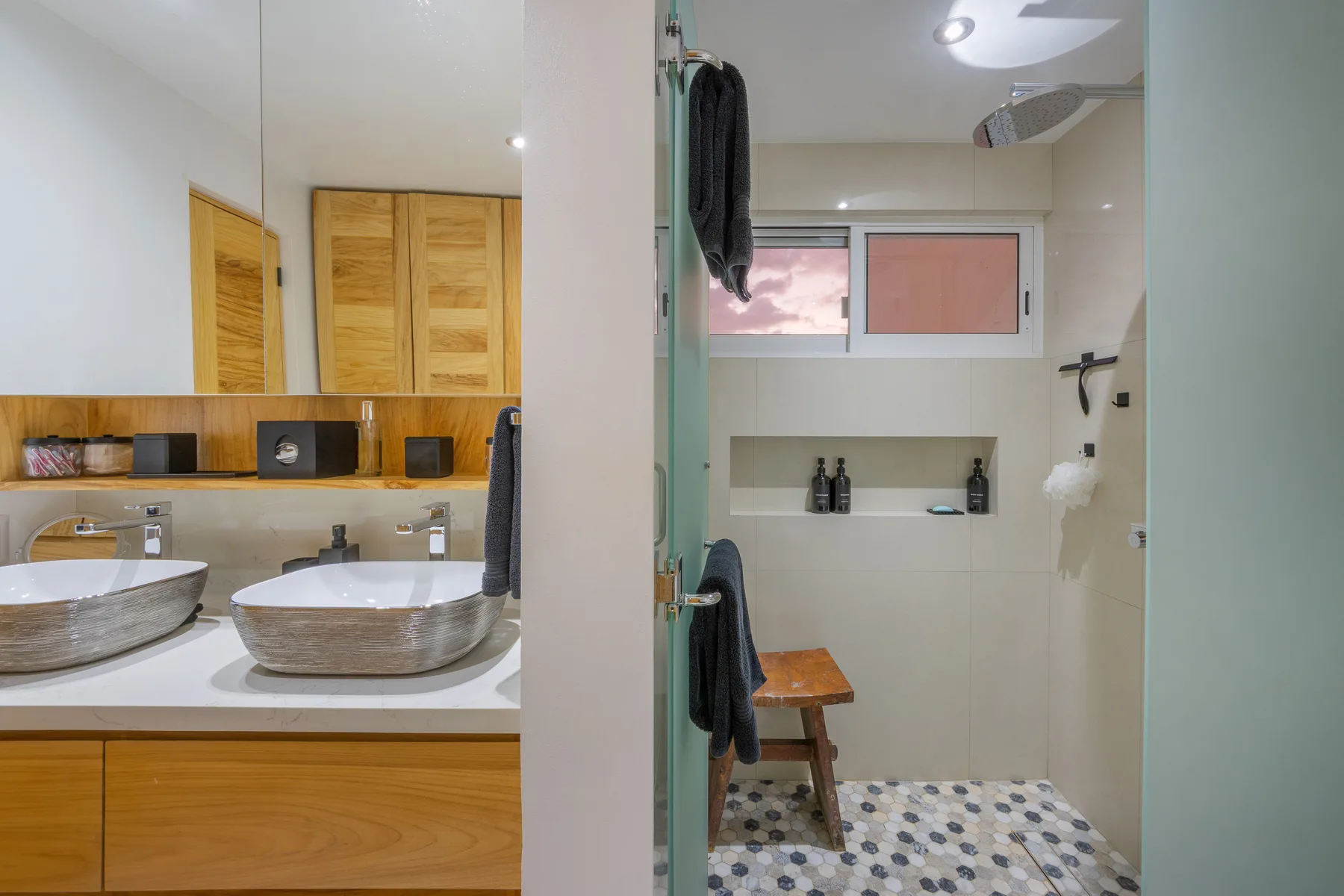 Primary bathroom with double vessel sinks and walk-in shower