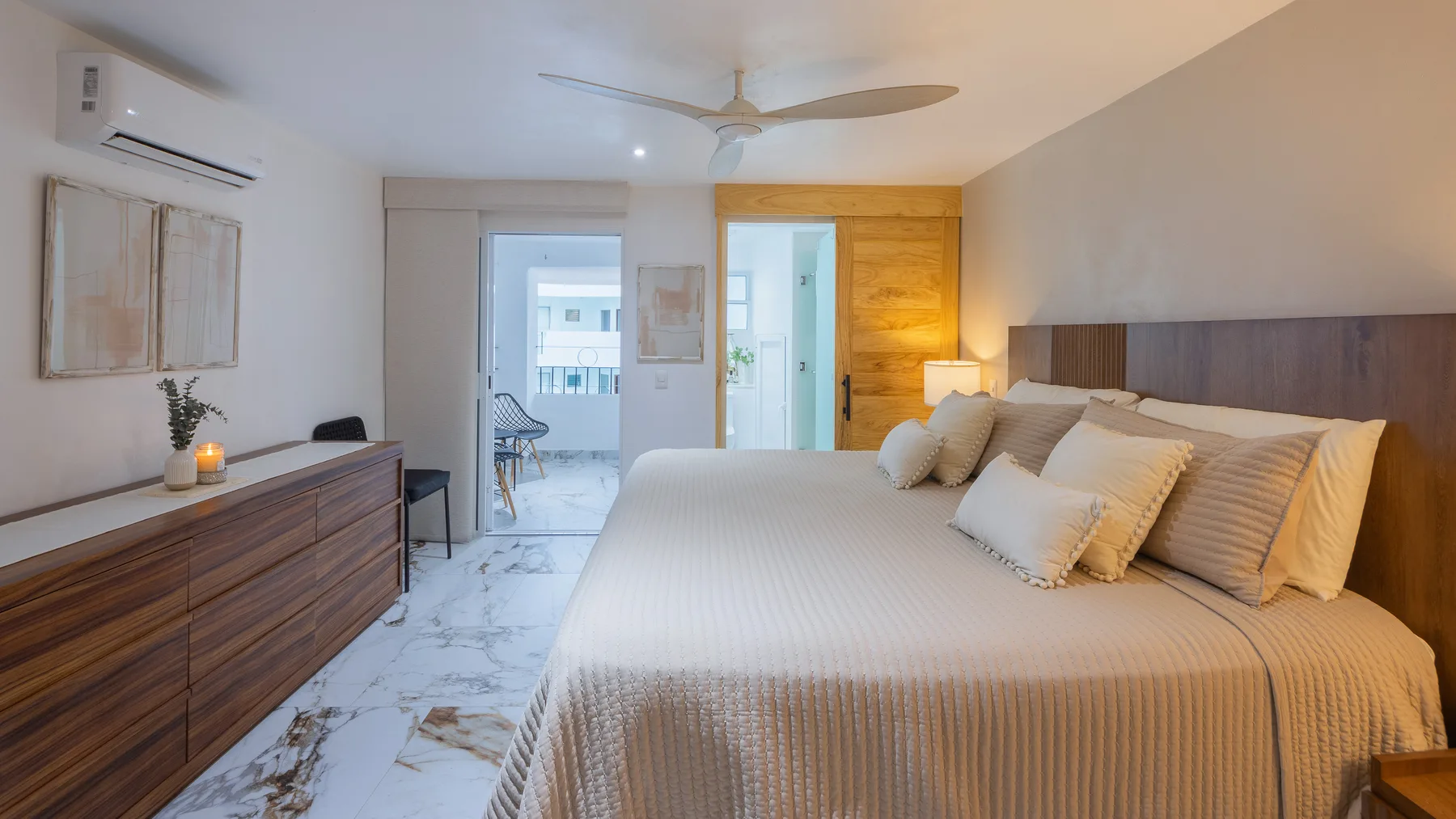 Second bedroom with walnut dresser and marble-look porcelain floors