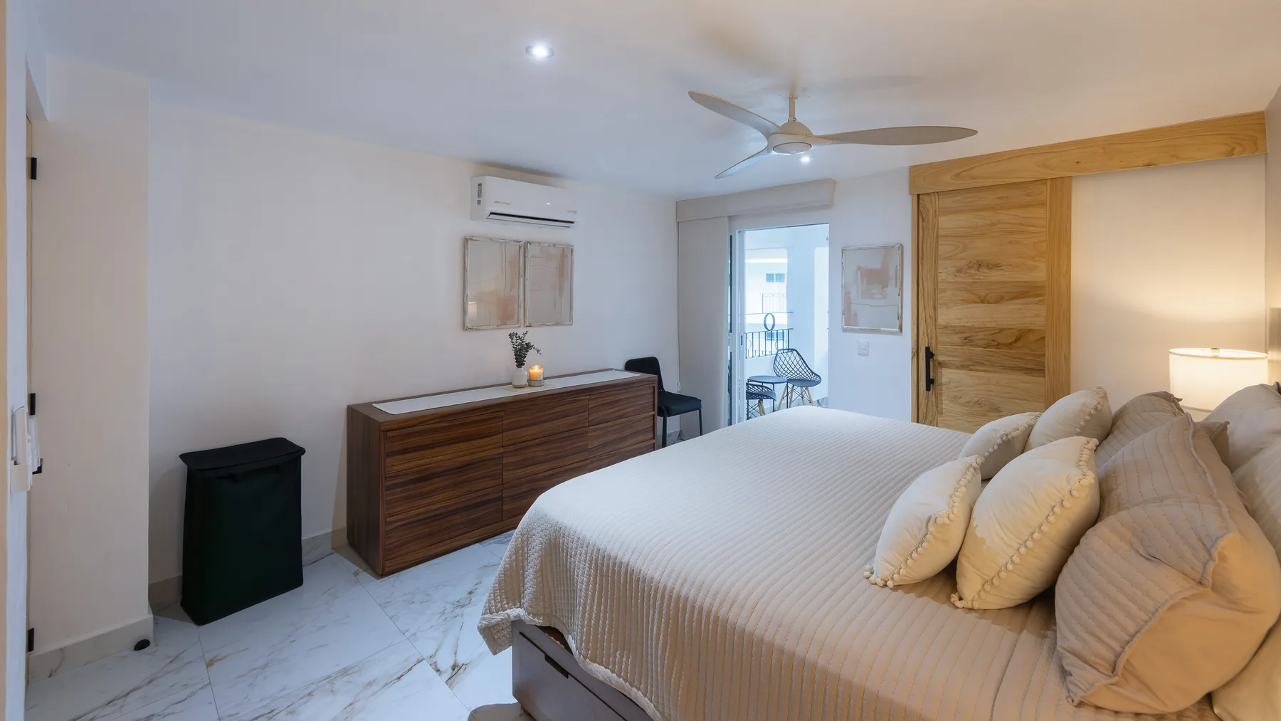 Second bedroom seen from the doorway, walnut dresser and terrace light