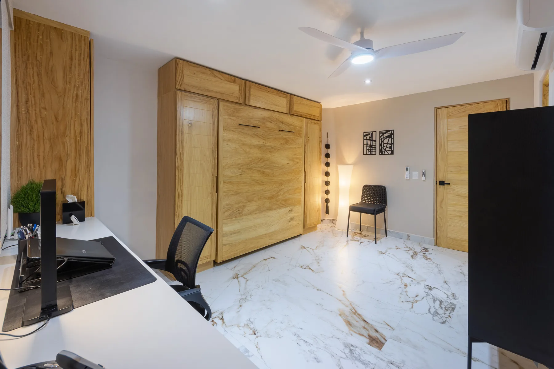 Third bedroom used as an office, with built-in desk, cabinetry and the Murphy bed stowed