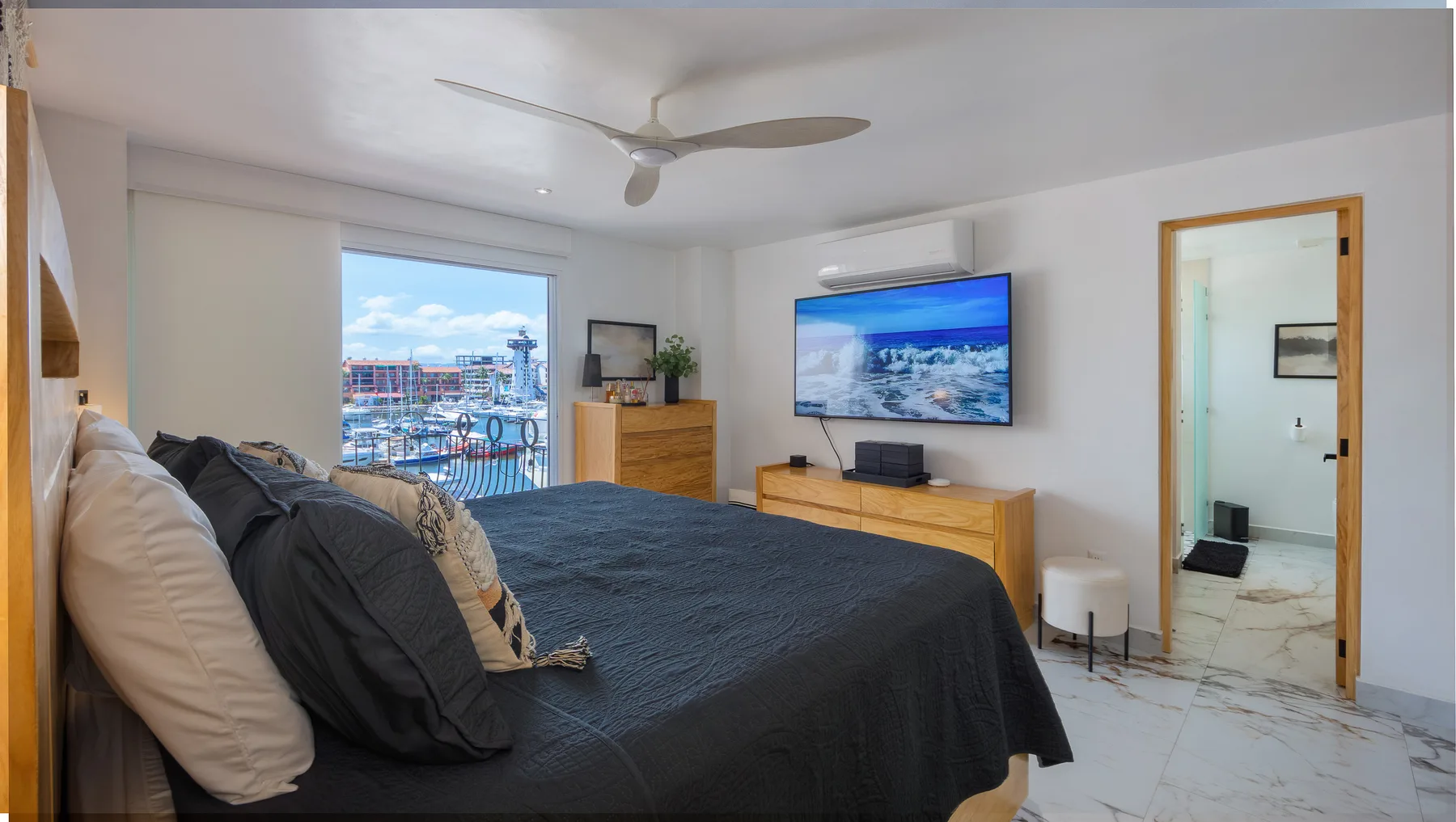 Primary bedroom with the marina visible through the window